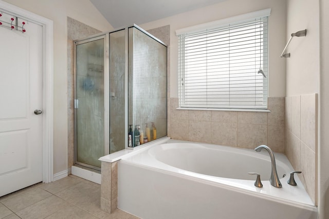 bathroom featuring tile patterned flooring and shower with separate bathtub