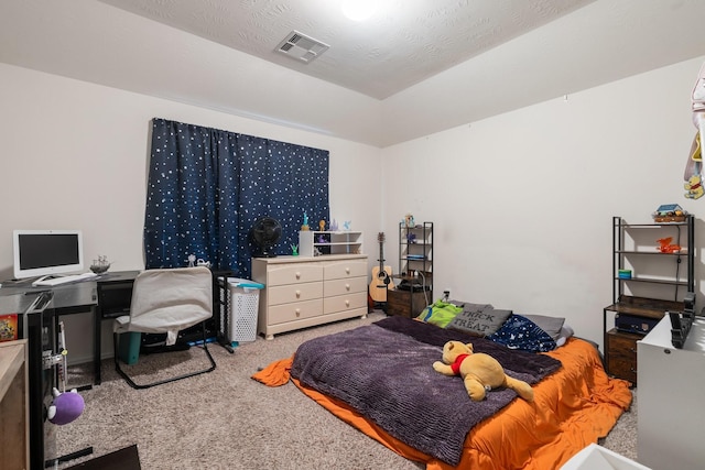 bedroom with carpet floors and a textured ceiling