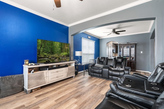 interior space with ornamental molding, ceiling fan, and light hardwood / wood-style flooring