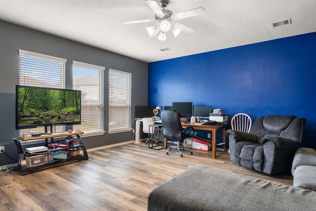 home office with hardwood / wood-style floors and ceiling fan