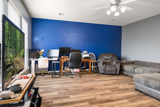 office with ceiling fan and light hardwood / wood-style flooring