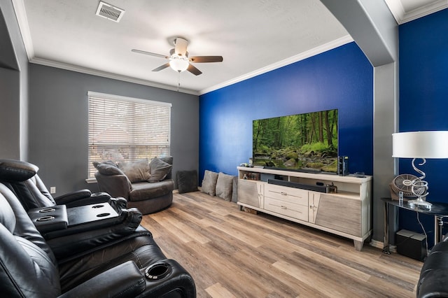 living room with hardwood / wood-style floors, ornamental molding, and ceiling fan