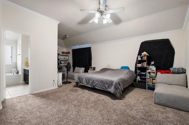 carpeted bedroom with ceiling fan, lofted ceiling, ornamental molding, and ensuite bath