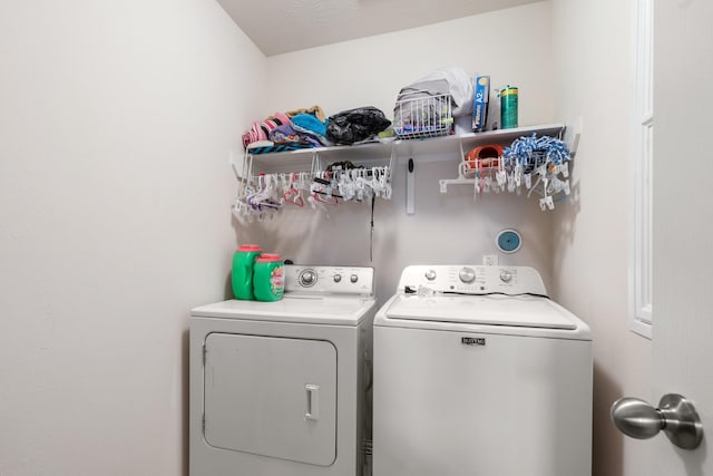 clothes washing area featuring separate washer and dryer