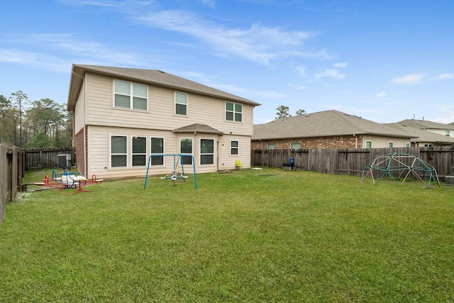 back of house featuring a yard and central AC unit