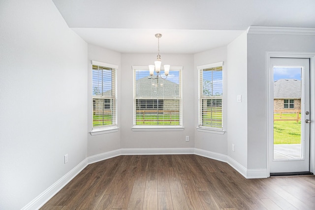 unfurnished dining area with dark wood-type flooring and a notable chandelier