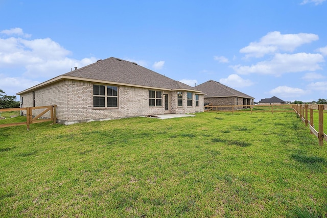 back of property featuring a yard and a patio