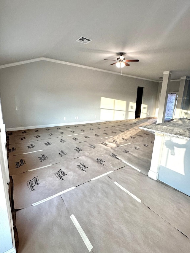 interior space with visible vents, a ceiling fan, vaulted ceiling, and crown molding