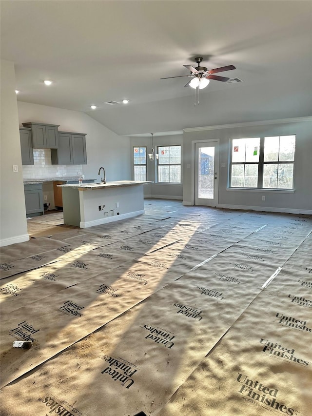 unfurnished living room with lofted ceiling, recessed lighting, visible vents, and baseboards