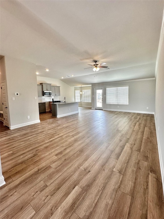 4318 Karam Lndg, Dickinson, TX 77539 - unfurnished living room featuring baseboards, wood finished floors, and a ceiling fan