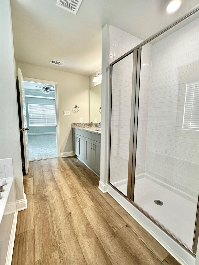 4318 Karam Lndg, Dickinson, TX 77539 - bathroom featuring visible vents, wood finished floors, a shower stall, and a bath