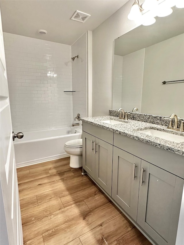 4318 Karam Lndg, Dickinson, TX 77539 - bathroom with visible vents, toilet, shower / bathing tub combination, wood finished floors, and a sink