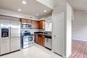 kitchen featuring light hardwood / wood-style floors and appliances with stainless steel finishes