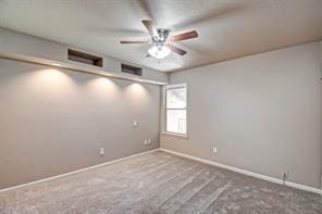 spare room featuring carpet flooring and ceiling fan