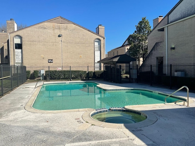 view of pool with a gazebo, a patio area, and a community hot tub