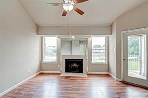 unfurnished living room featuring wood-type flooring and ceiling fan