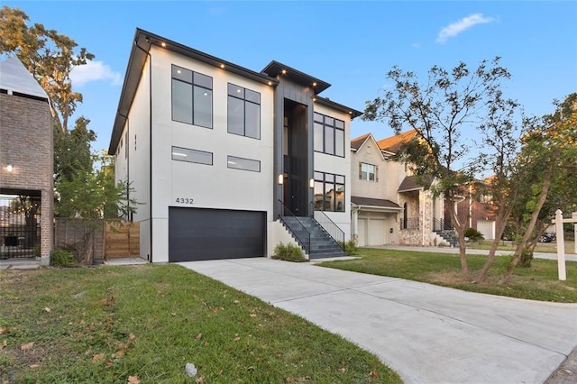 modern home featuring a garage and a front lawn