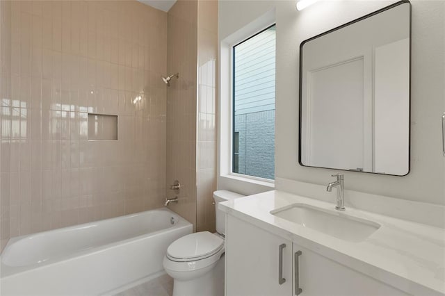 full bathroom featuring tiled shower / bath combo, vanity, and toilet