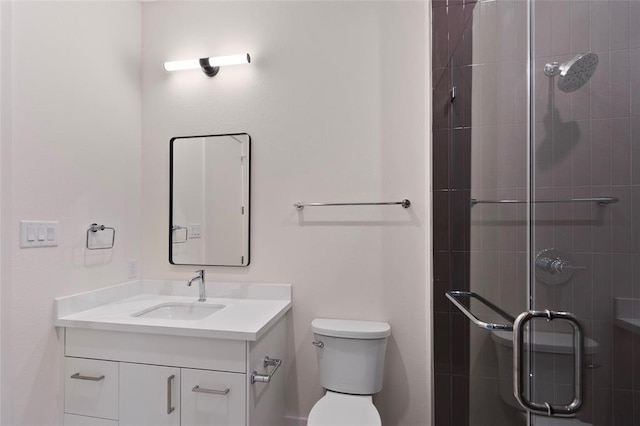 bathroom featuring vanity, toilet, and an enclosed shower