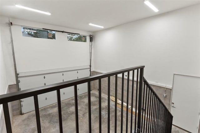 stairs featuring concrete flooring