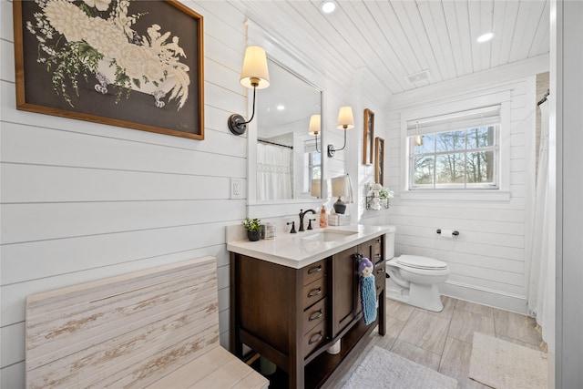 bathroom with walk in shower, toilet, wooden ceiling, ornamental molding, and vanity