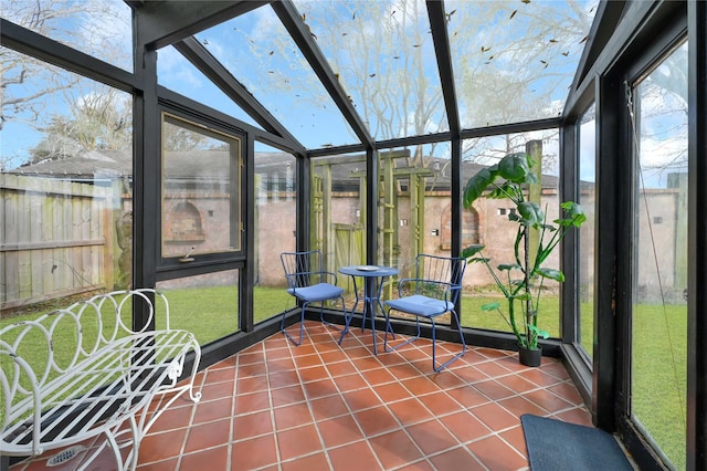 unfurnished sunroom with a wealth of natural light and vaulted ceiling