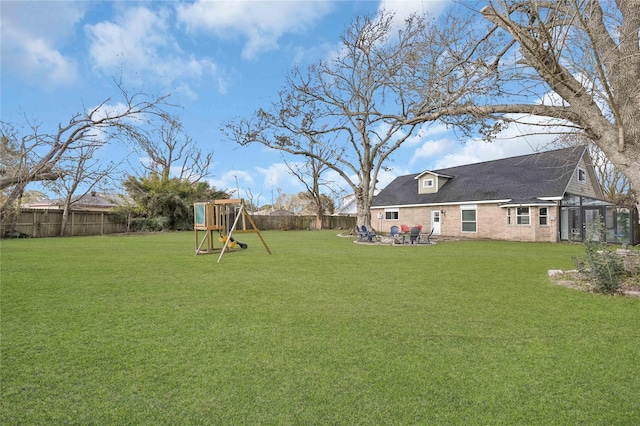 view of yard featuring a playground and a patio