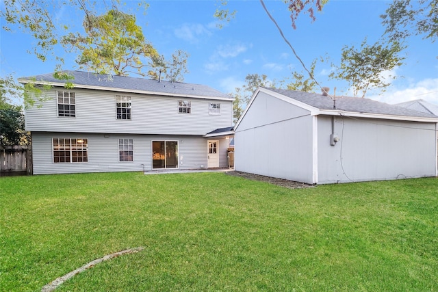 rear view of house featuring a yard