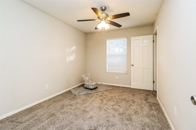 spare room with ceiling fan and carpet