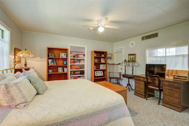 carpeted bedroom featuring visible vents and ceiling fan