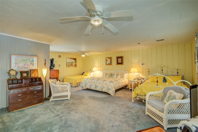 carpeted bedroom with ceiling fan and visible vents