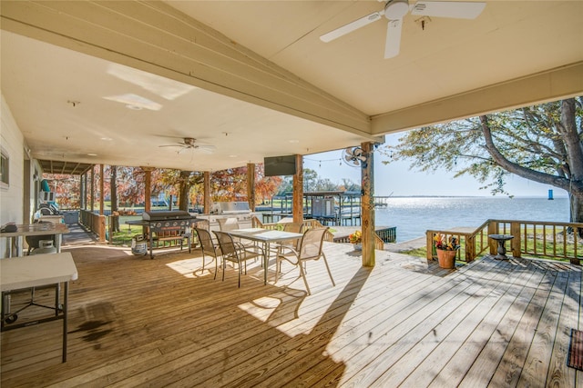 deck with outdoor dining area and ceiling fan