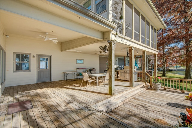 wooden terrace with ceiling fan, outdoor dining space, and a sunroom