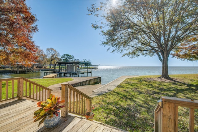 wooden terrace featuring a yard and a water view