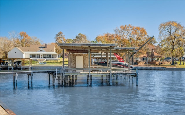 dock area with a water view and boat lift