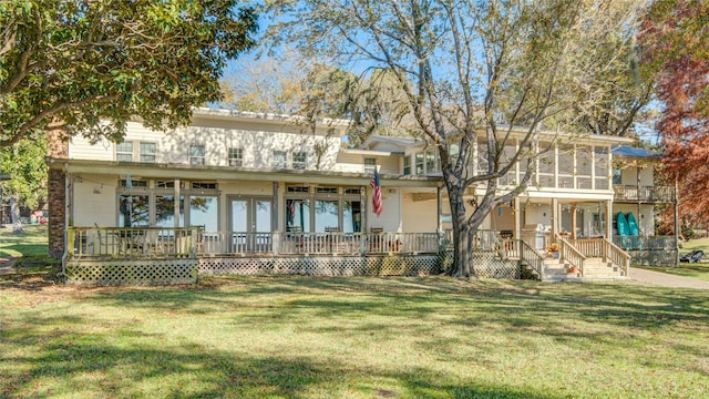 view of front of home with a sunroom and a front yard