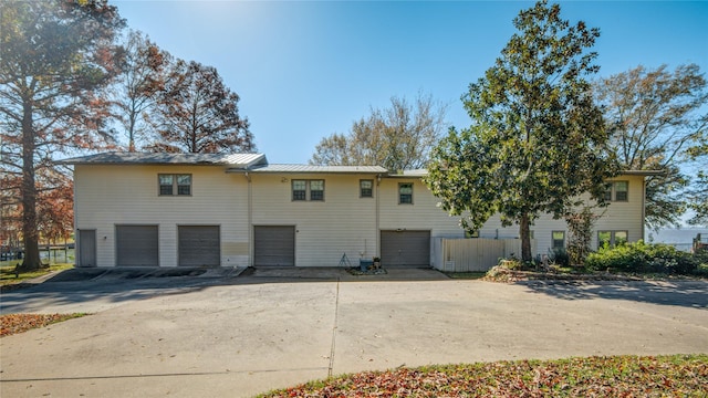 exterior space with metal roof, concrete driveway, and a garage