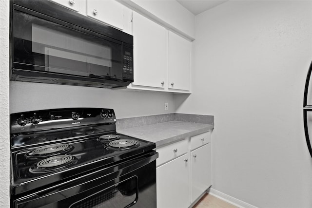 kitchen featuring white cabinets and black appliances