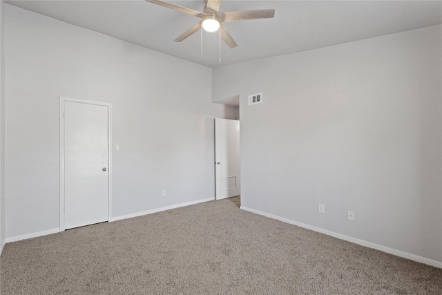 empty room with ceiling fan, lofted ceiling, and carpet floors