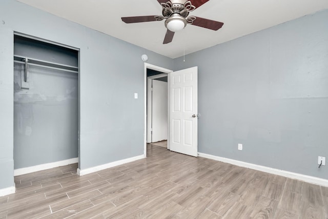 unfurnished bedroom with ceiling fan, a closet, and light wood-type flooring