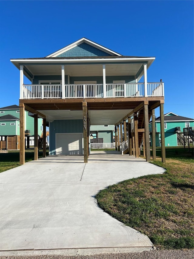 exterior space featuring a garage, a front lawn, a carport, and covered porch