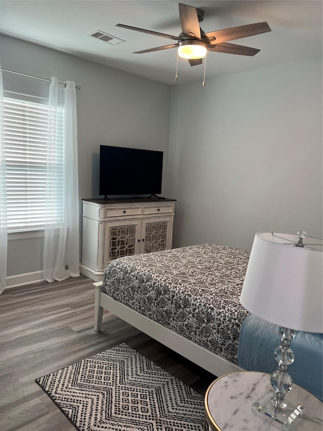 bedroom featuring hardwood / wood-style flooring and ceiling fan