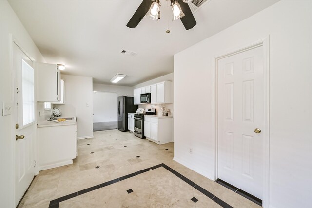 kitchen featuring light tile patterned floors, ceiling fan, stainless steel appliances, decorative backsplash, and white cabinets