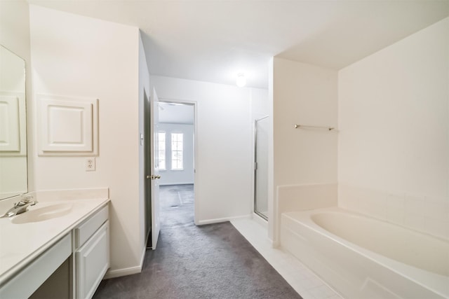 full bathroom featuring a stall shower, baseboards, a bath, and vanity