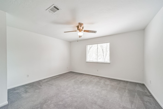 spare room featuring ceiling fan and carpet