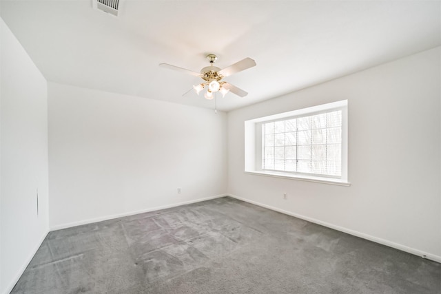 spare room featuring ceiling fan, carpet, visible vents, and baseboards