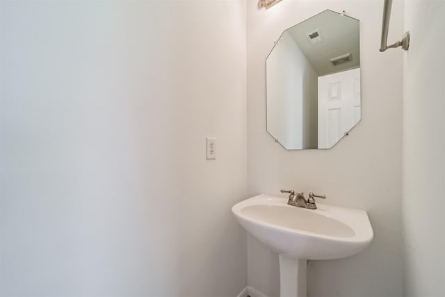 bathroom featuring visible vents and a sink