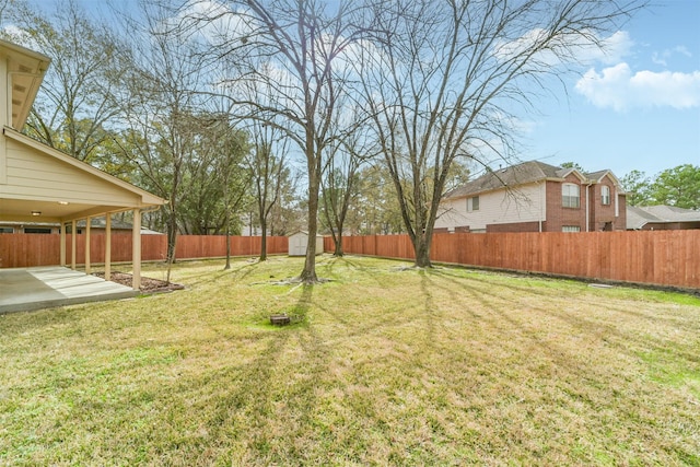 view of yard with a storage shed, a fenced backyard, an outdoor structure, and a patio