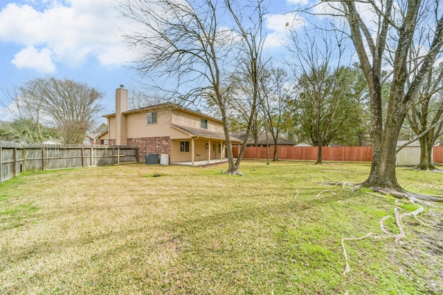 view of yard featuring cooling unit, a fenced backyard, and a patio