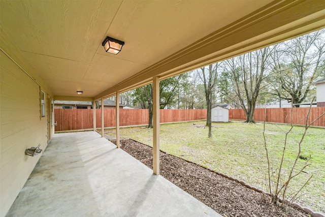 view of patio featuring a shed, a fenced backyard, and an outdoor structure